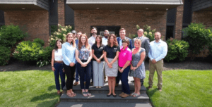 Image of employees from ASMAI post in front of our office building