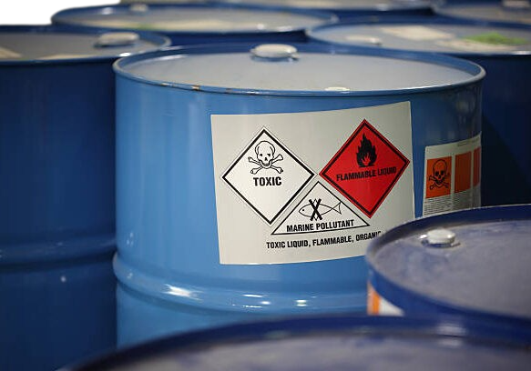 image of a light blue container with hazardous waste warnings on it