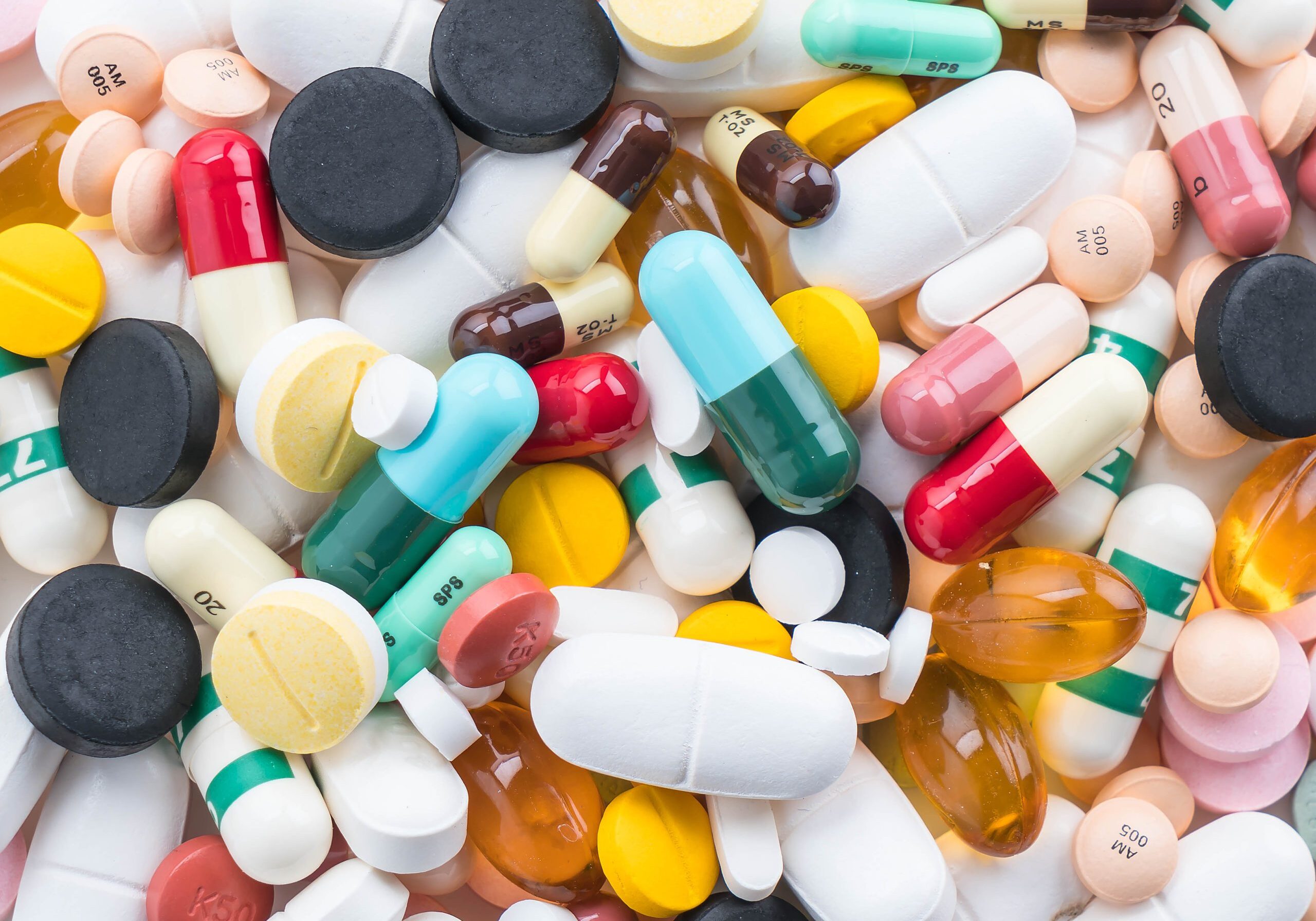 Close-up of scattered medications highlighting the importance of proper pharmaceutical waste disposal practices.