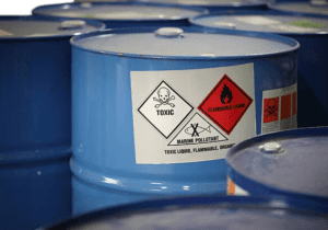 image of a light blue container with hazardous waste warnings on it