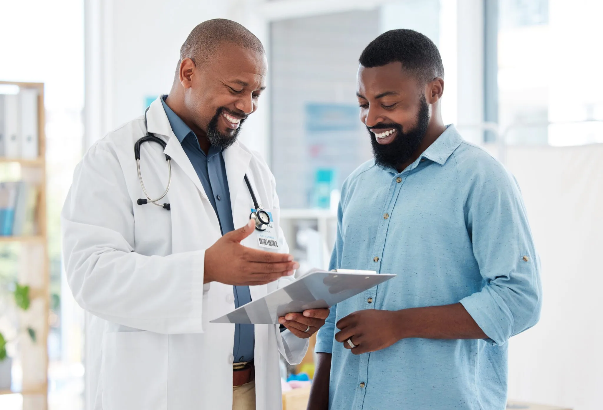 Image of a doctor speaking with a patient in an exam room