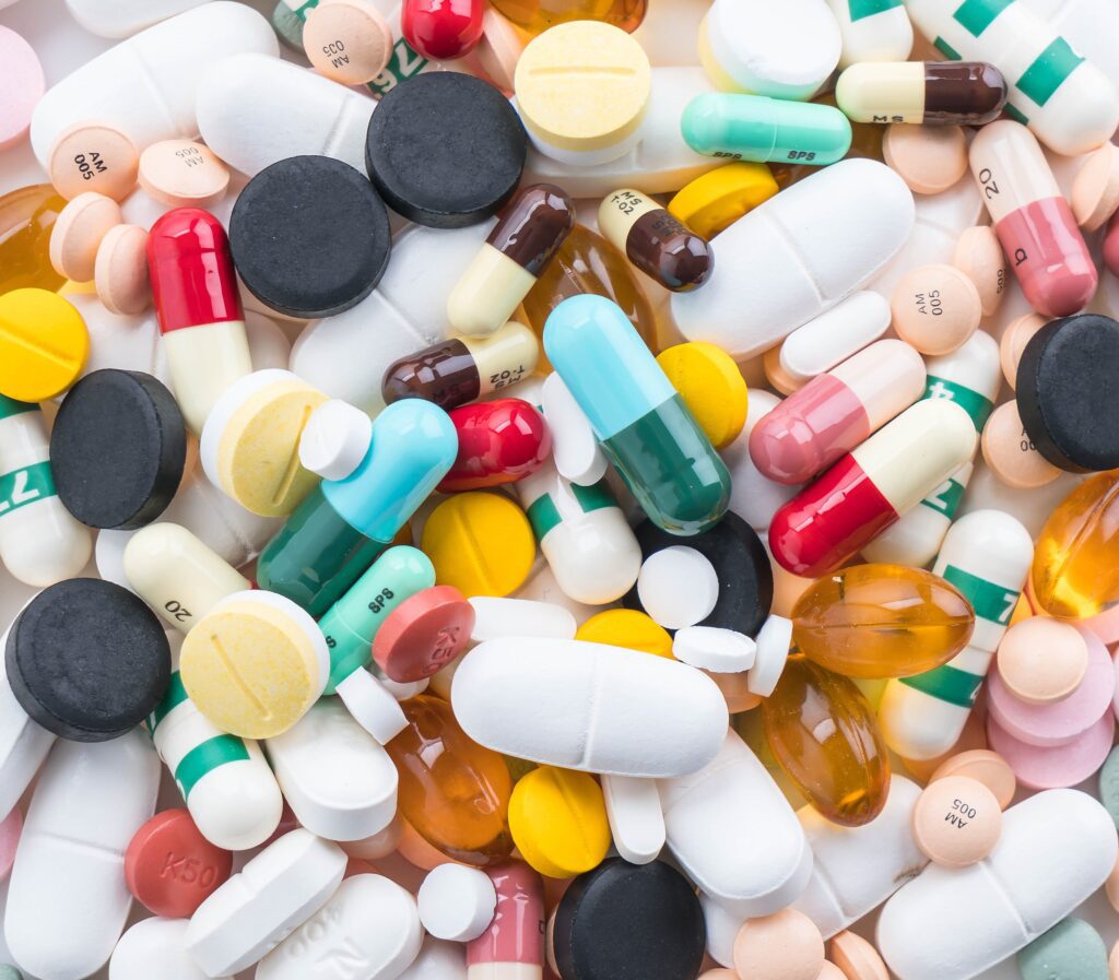 Close-up of scattered medications highlighting the importance of proper pharmaceutical waste disposal practices.